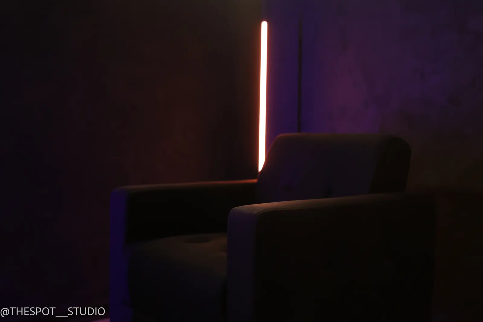 Armchair in the Black Room beside the orange LED bar