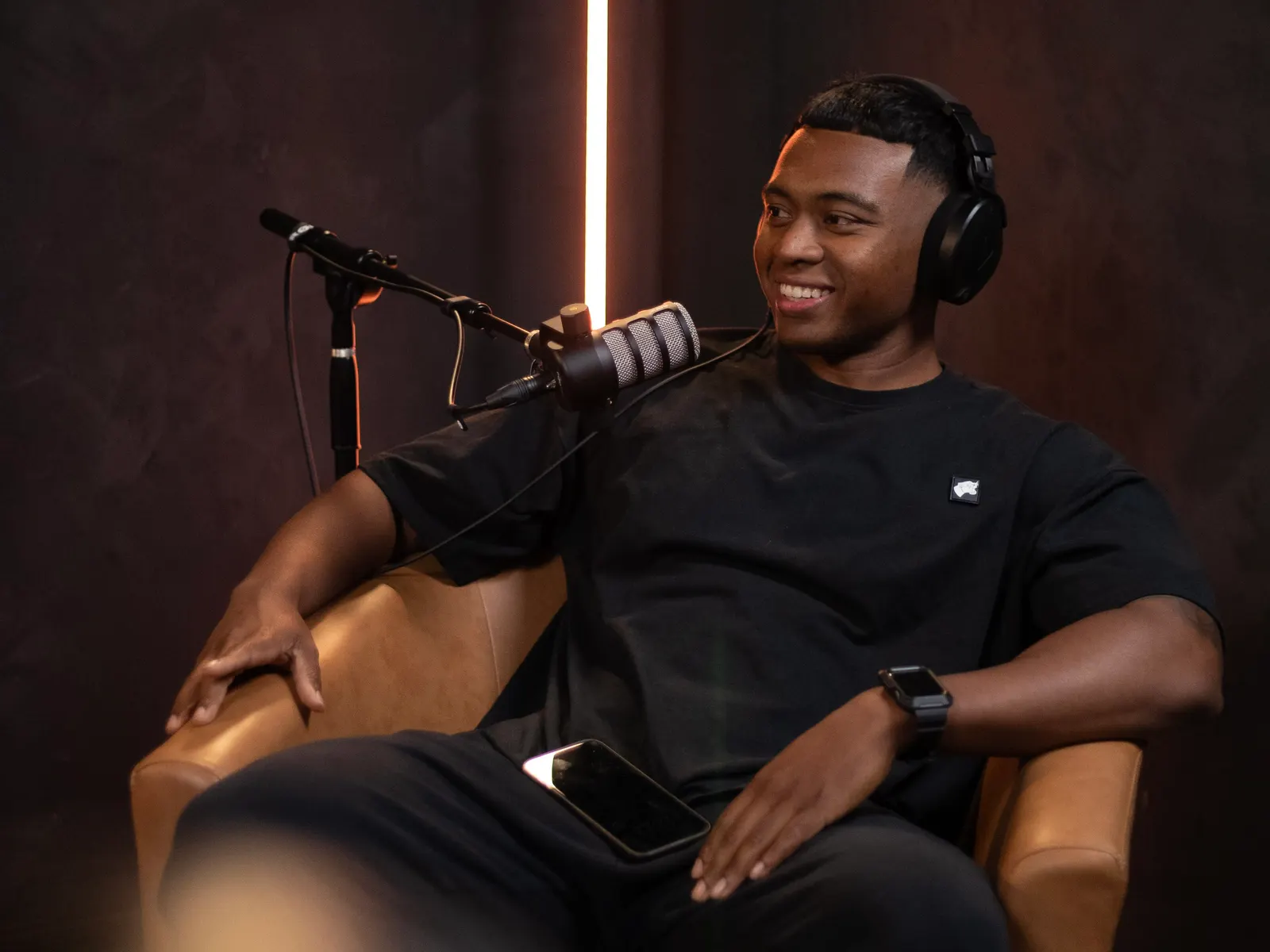 Guest with headphones recording in the Black Room