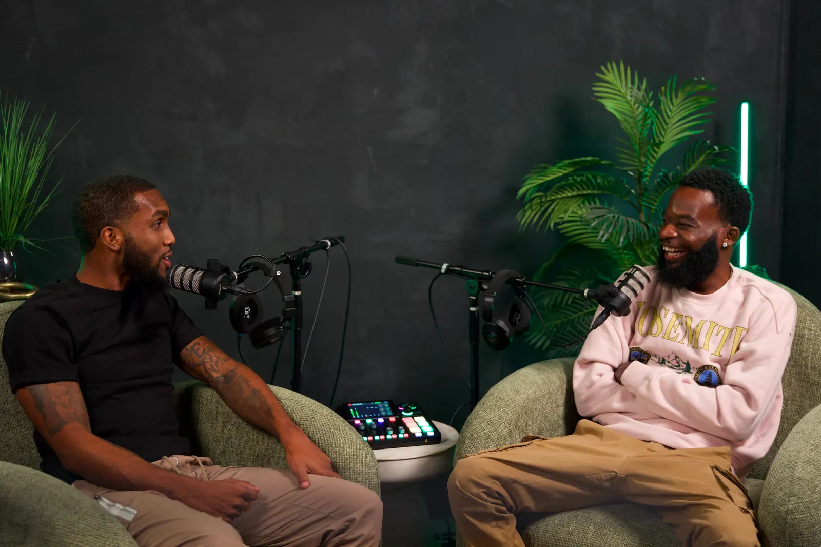 Two hosts recording a session in the Black Room
