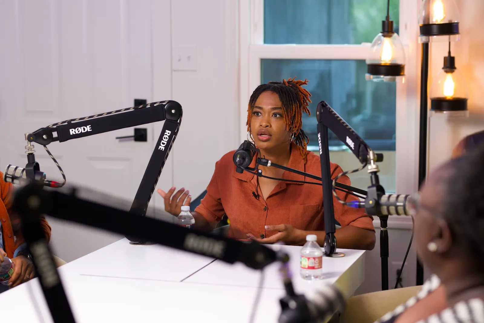 Roundtable session with podcast microphones in the Primary Studio